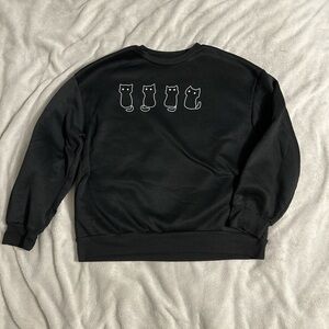 This BLACK sweatshirt is a size SMALL (CAN BE WORN AS XS)